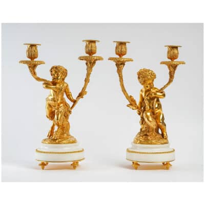 Pair of Louis XVI style candlesticks in gilded bronze Un Amour et Un Faune after Clodion and Delarue