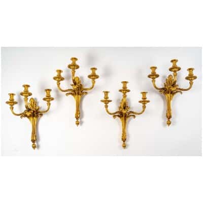 Series of four Transition style sconces in gilded bronze. XIX th century.