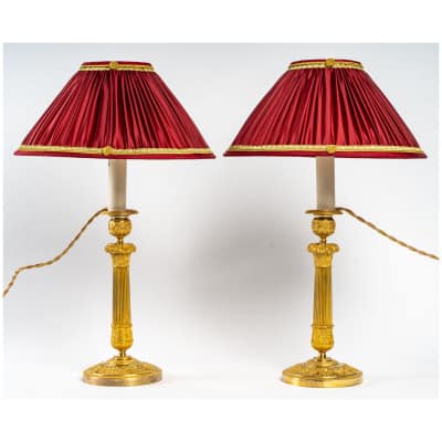 Paire de flambeaux montés en lampes à décor de panier fleuri en bronze doré époque Restauration vers 1820