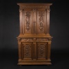Buffet two bodies with the attributes of the war in carved walnut, XIXand 10