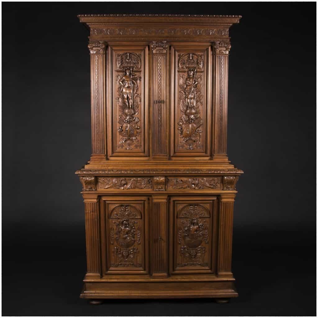 Buffet two bodies with the attributes of the war in carved walnut, XIXand 3