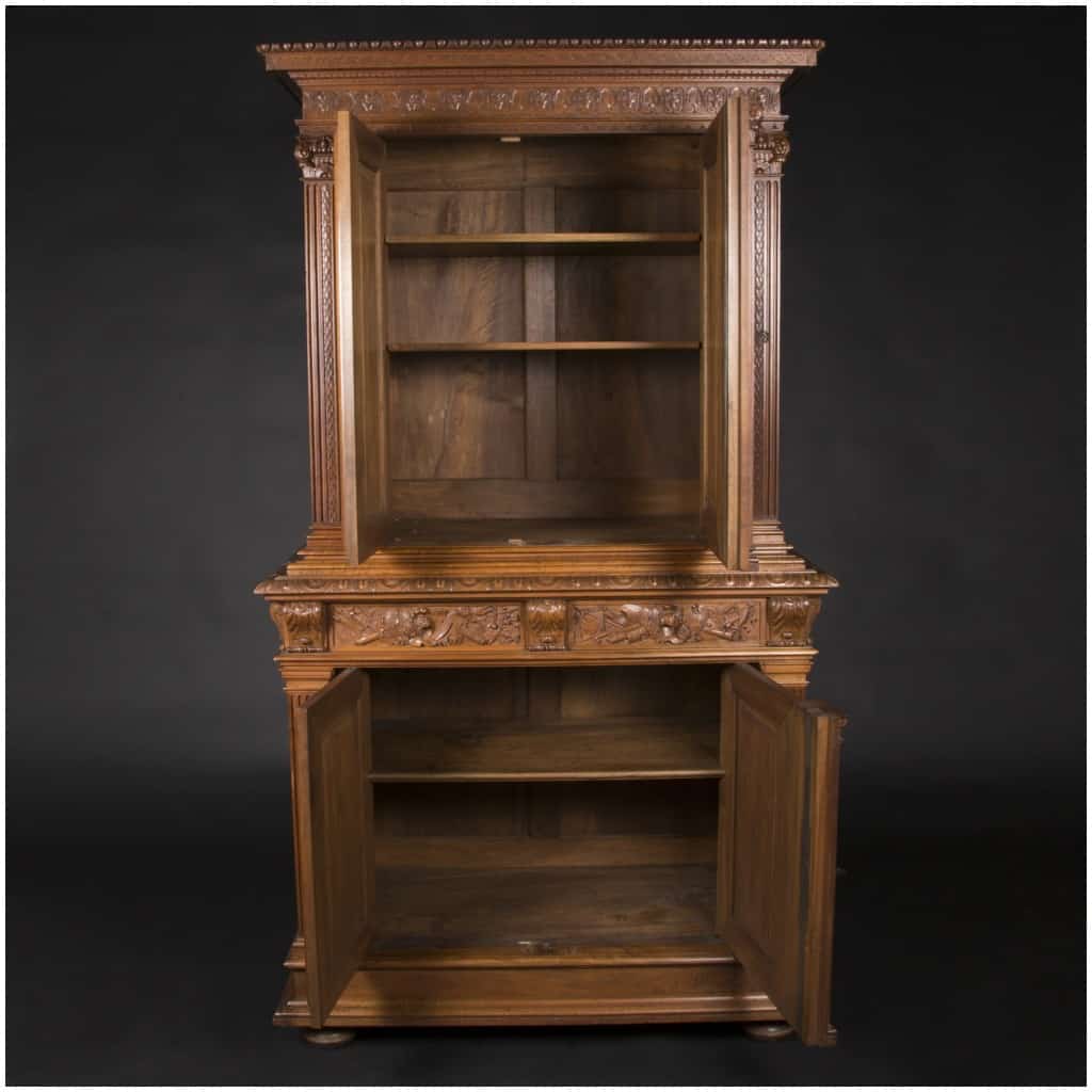 Buffet two bodies with the attributes of the war in carved walnut, XIXand 4