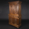 Buffet two bodies with the attributes of the war in carved walnut, XIXand 12