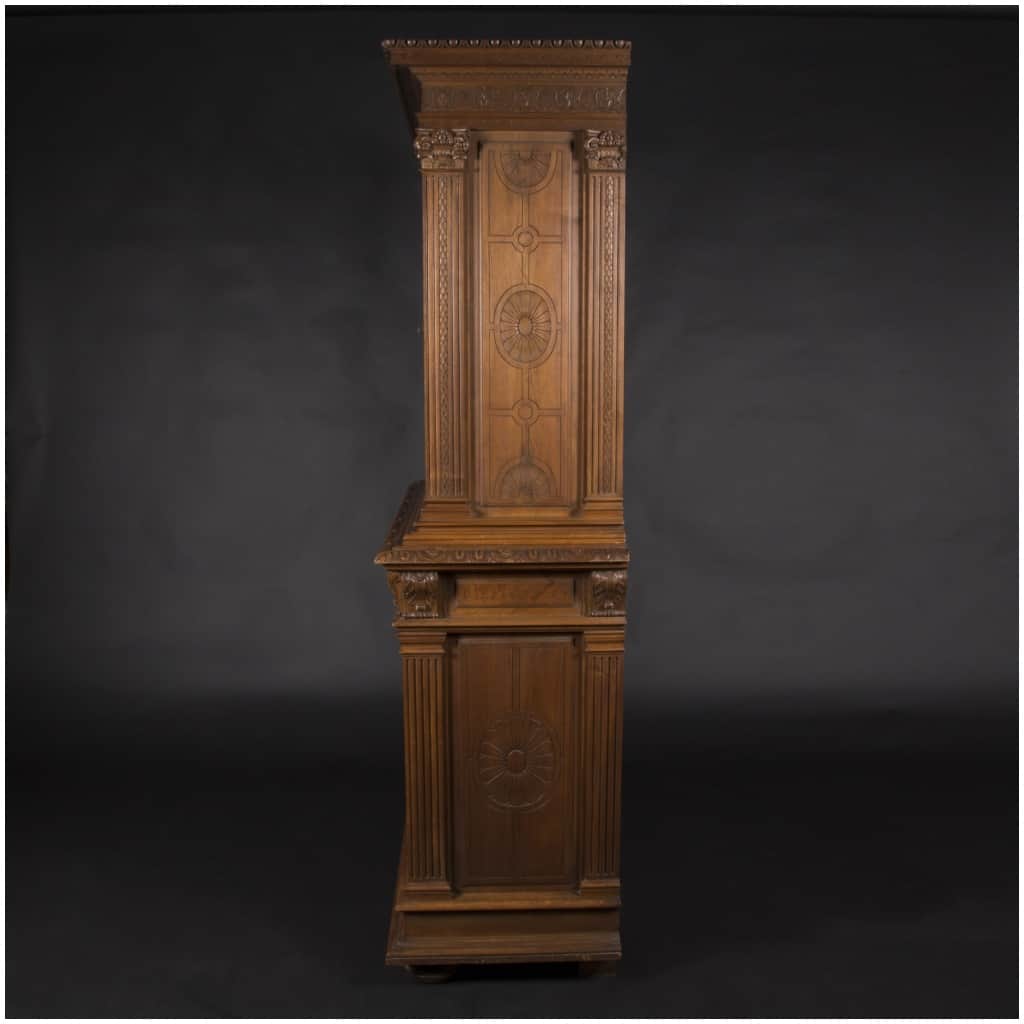 Buffet two bodies with the attributes of the war in carved walnut, XIXand 6