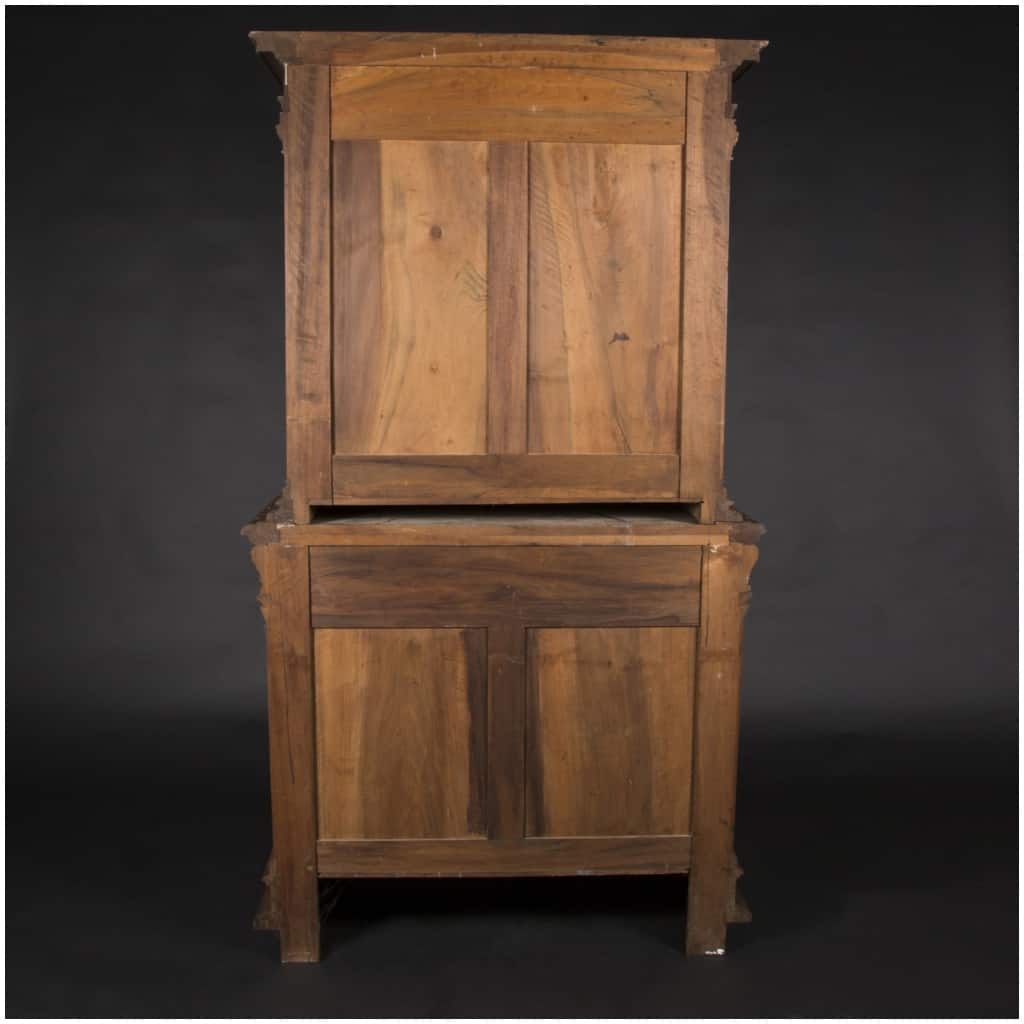 Buffet two bodies with the attributes of the war in carved walnut, XIXand 7
