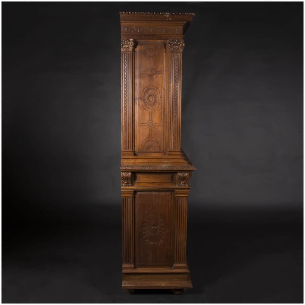 Buffet two bodies with the attributes of the war in carved walnut, XIXand 8