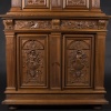 Buffet two bodies with the attributes of the war in carved walnut, XIXand 16