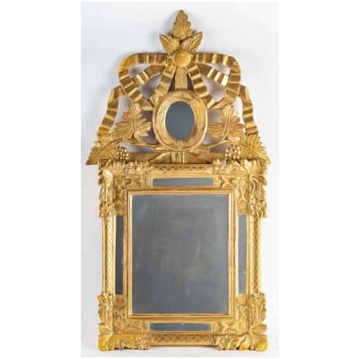 Gilt wood mirror with glazing beads and openwork pediment, Louis period XVI to 1780