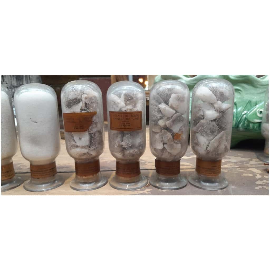 Collection of 7 inverted bottles containing different states of natural sodium nitrate from Chile 5